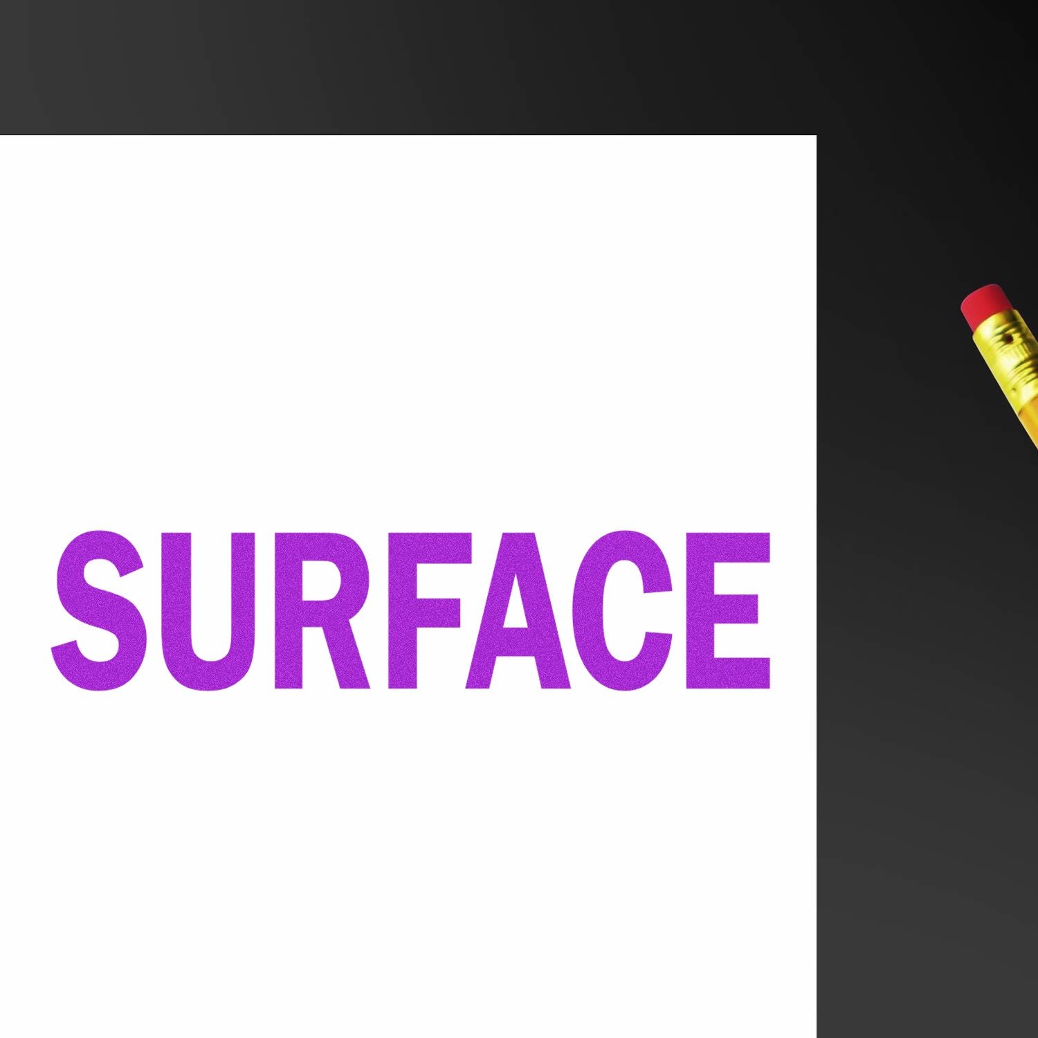 Surface Rubber Stamp in use, creating a bold purple 'SURFACE' imprint on white paper, with a pencil visible on the side.