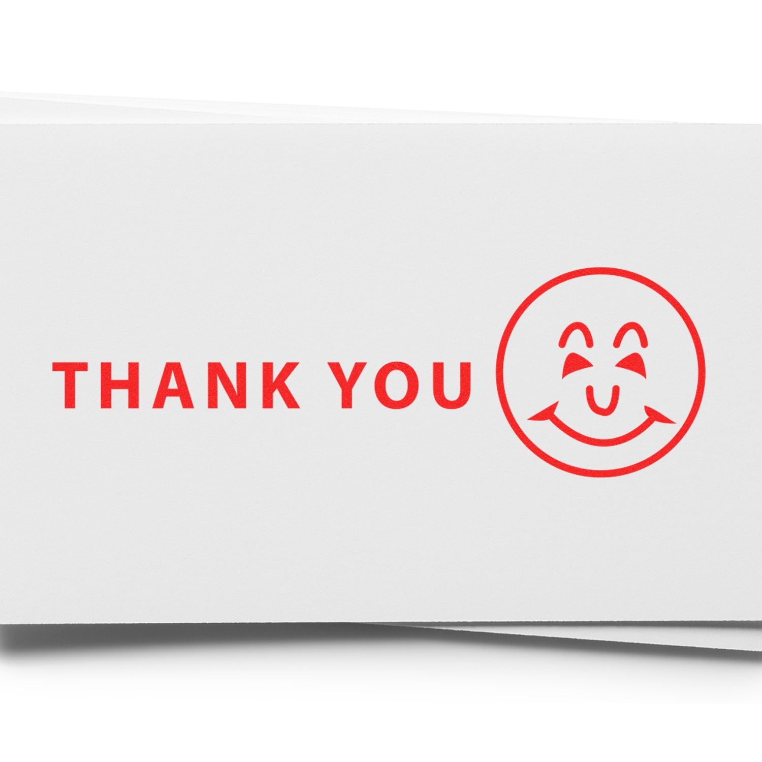 Large Thank You with Smiley Rubber Stamp in red ink on white paper, featuring a smiling face next to the words THANK YOU .