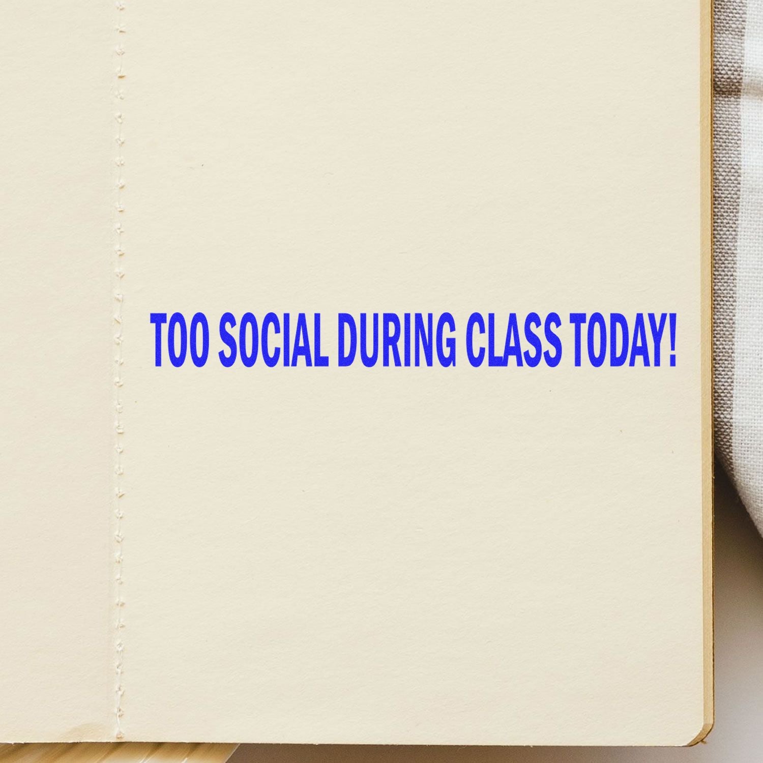 Too Social During Class Today Rubber Stamp impression in blue ink on an open notebook page.