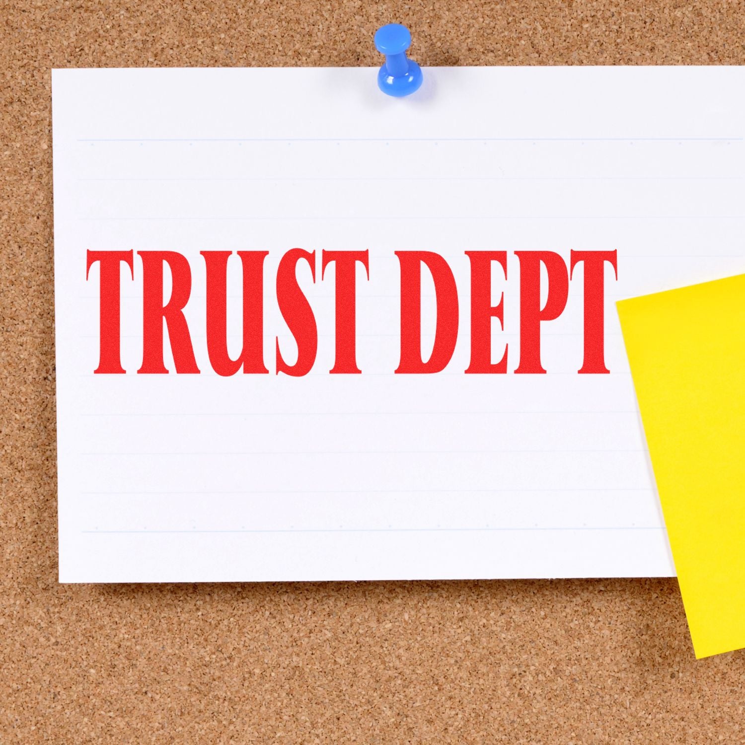 Trust Dept Rubber Stamp in red ink on a white card pinned to a corkboard with a blue pushpin and a yellow sticky note.