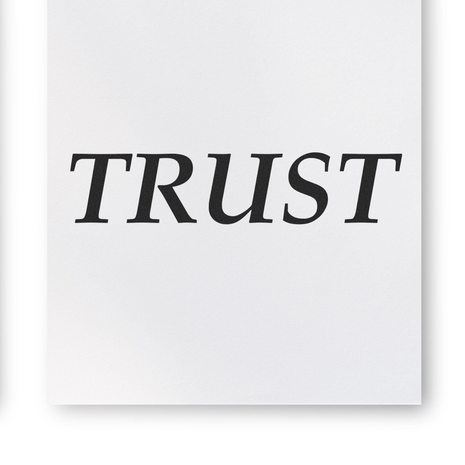 A sheet of paper stamped with the word TRUST using the Self Inking Trust Stamp, showcasing its clear and bold imprint.