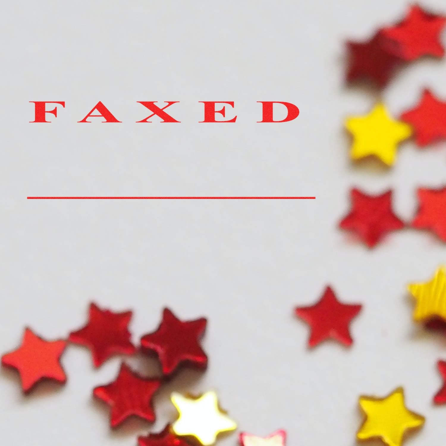 Slim Pre-Inked Faxed Stamp in Two Lines with red FAXED text and a blank line below, surrounded by red and yellow star confetti.