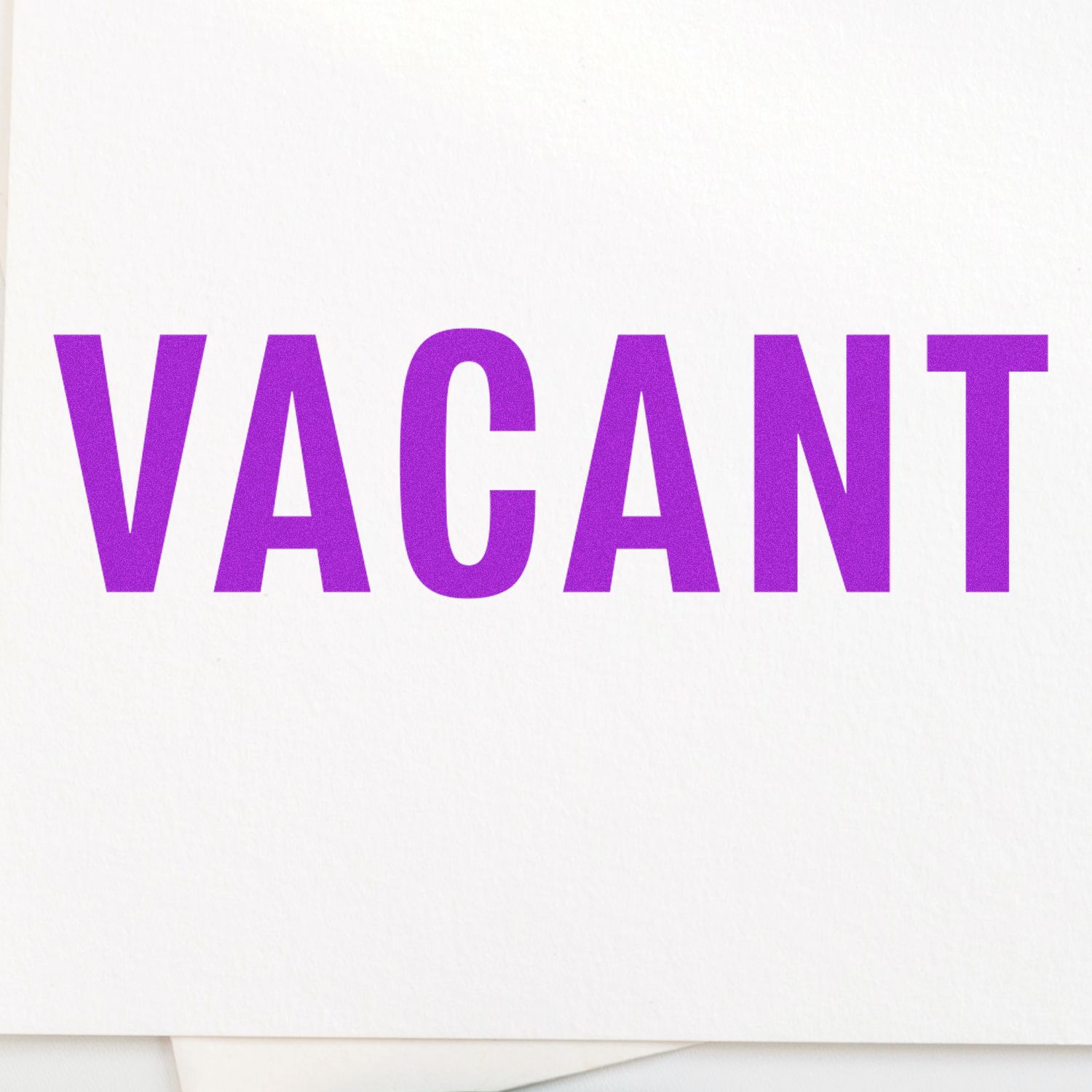 Vacant Rubber Stamp in use, displaying the word "VACANT" in bold purple letters on a white background.