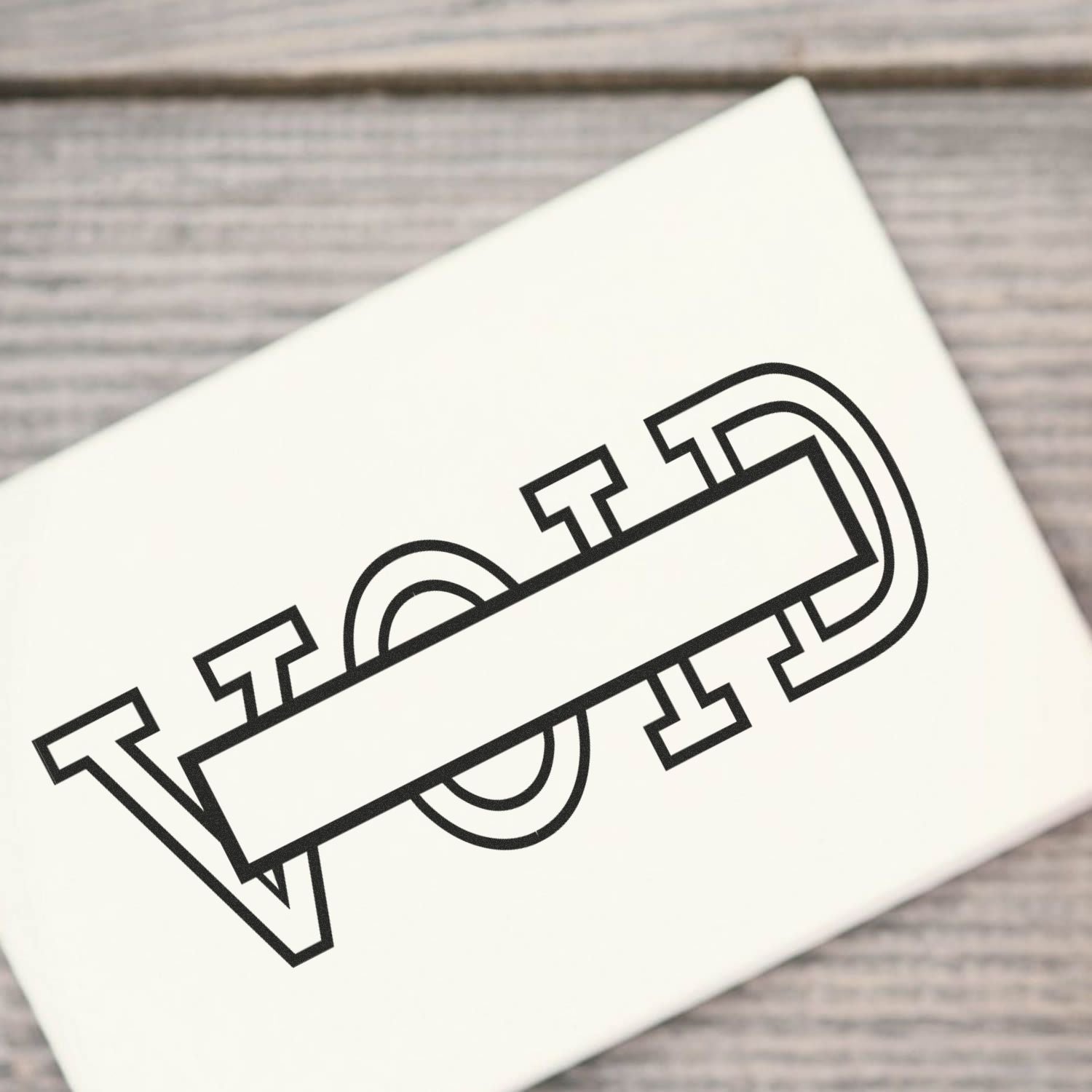 Large Void with Box Rubber Stamp on white paper, showing the word VOID with a rectangular box in the middle, on a wooden surface.