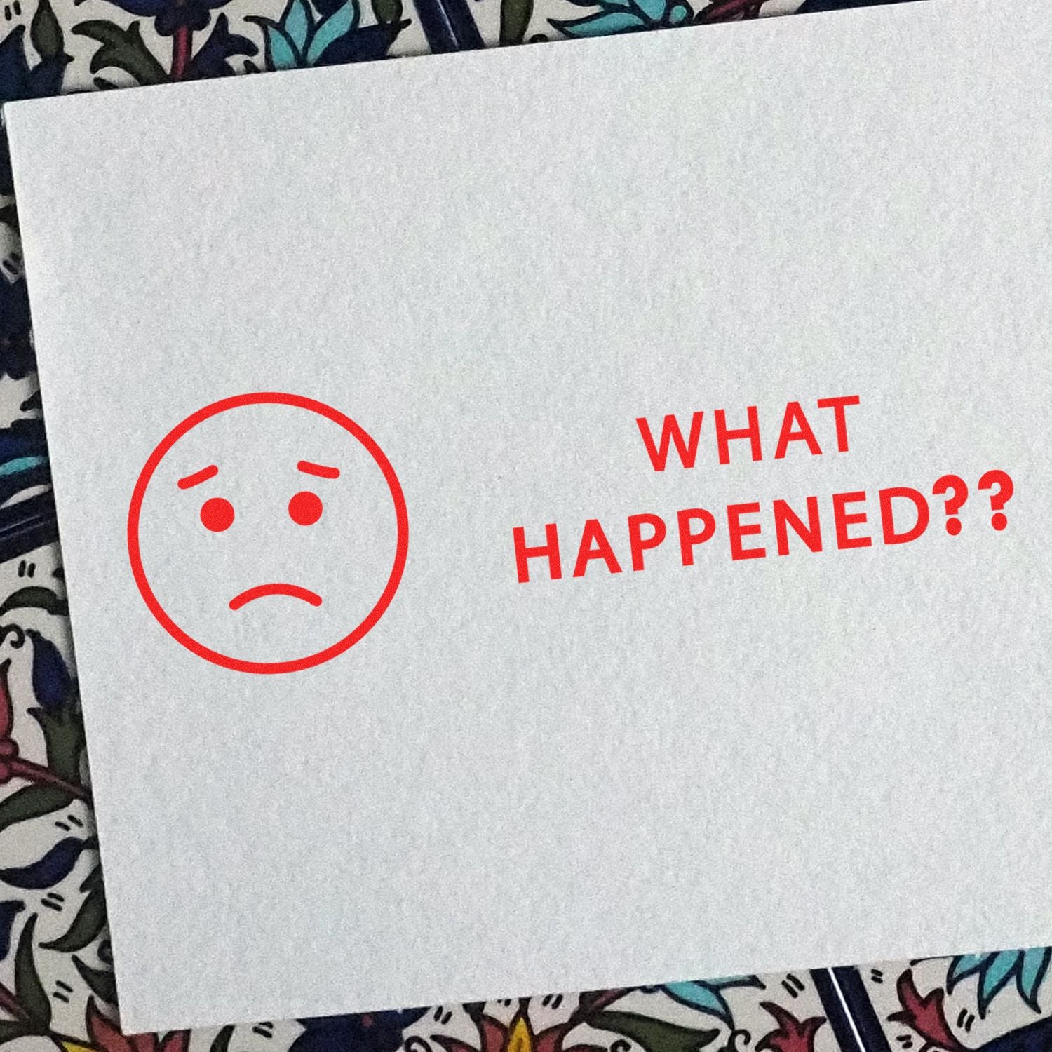 Slim Pre-Inked What Happened Stamp in red ink on white paper, featuring a sad face emoji and the text WHAT HAPPENED?? .