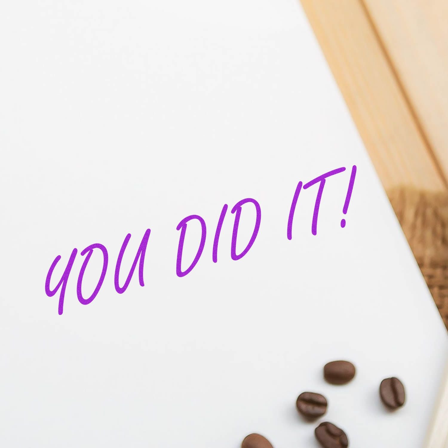 You Did It Rubber Stamp in purple ink on white paper, with coffee beans scattered nearby on a wooden surface.