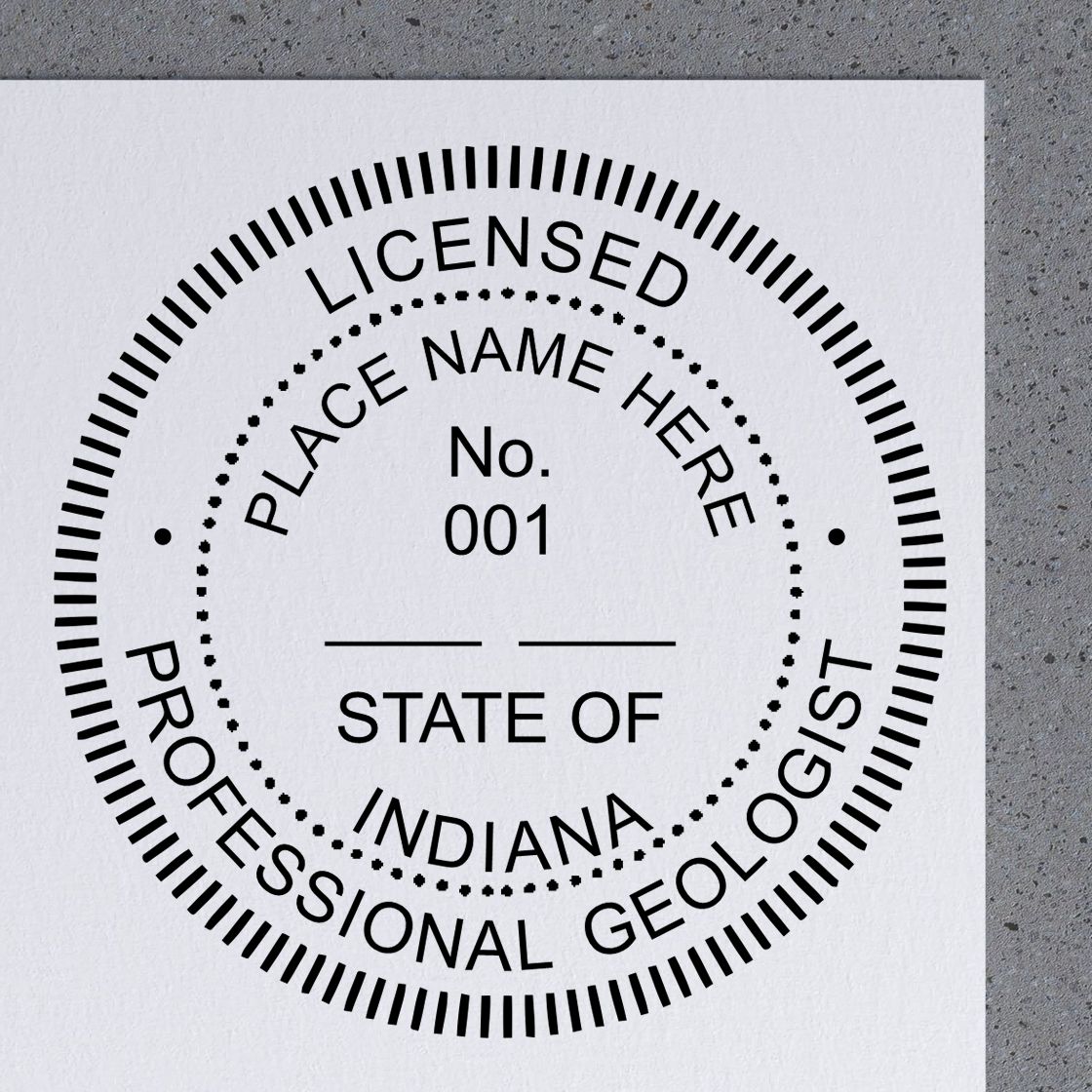 A lifestyle photo showing a stamped image of the Slim Pre-Inked Indiana Professional Geologist Seal Stamp on a piece of paper