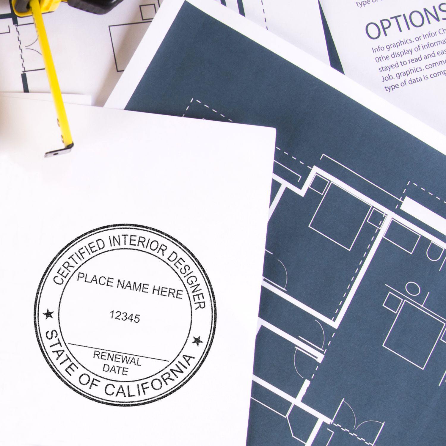 Interior Designer Regular Rubber Stamp of Seal on a white paper, next to architectural blueprints and design documents.