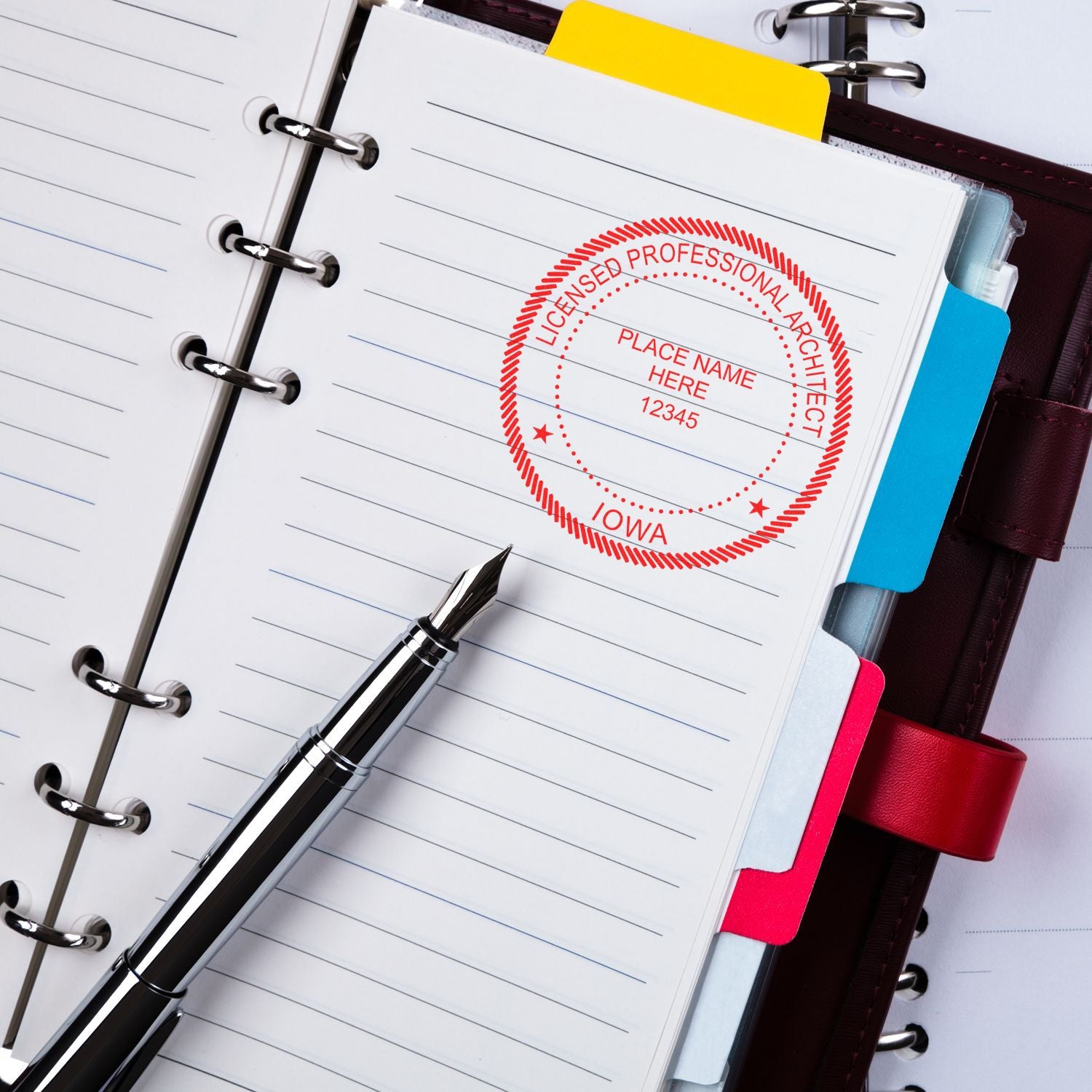 Premium MaxLight Pre-Inked Iowa Architectural Stamp in use on a notebook with a fountain pen nearby.