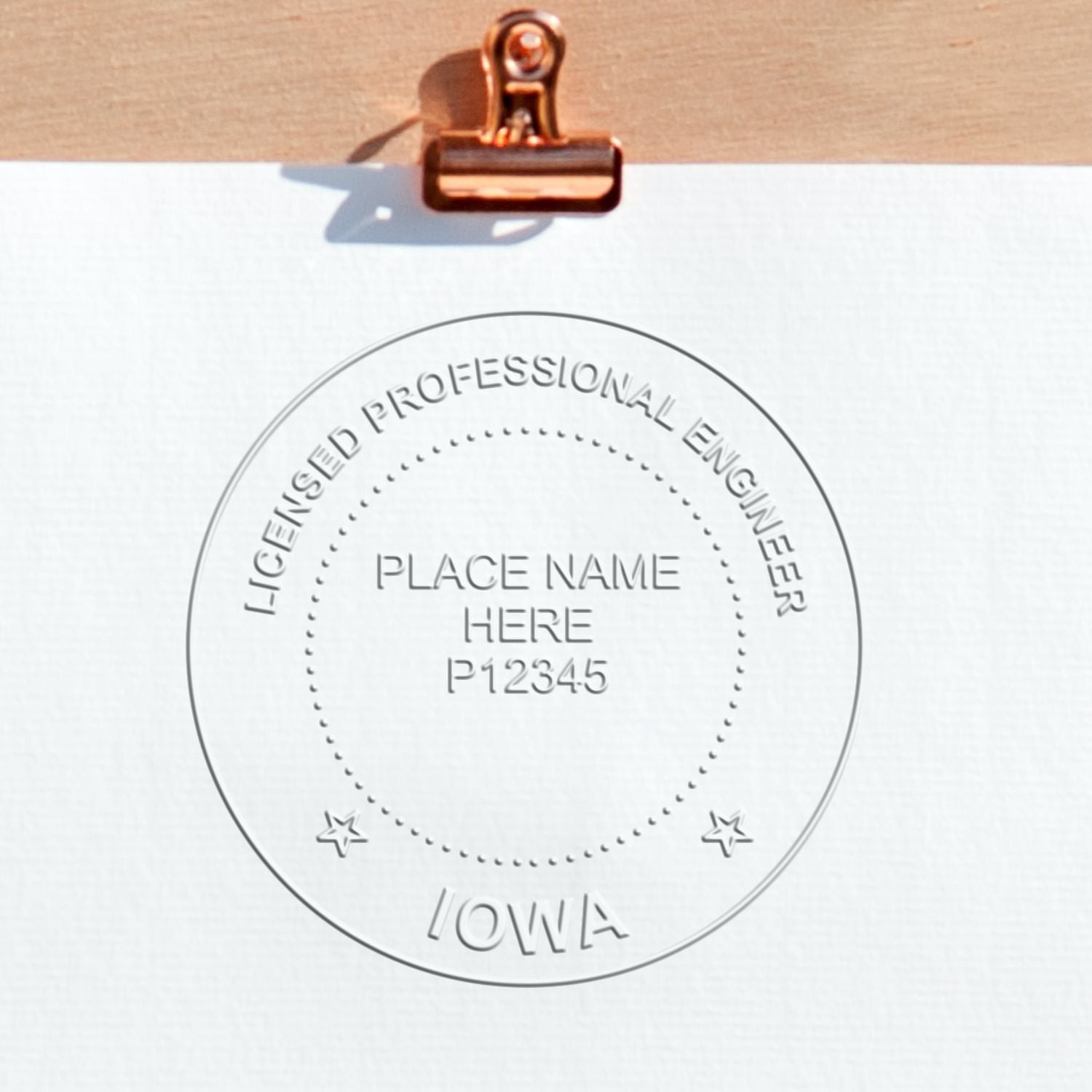A lifestyle photo showing a stamped image of the Handheld Iowa Professional Engineer Embosser on a piece of paper