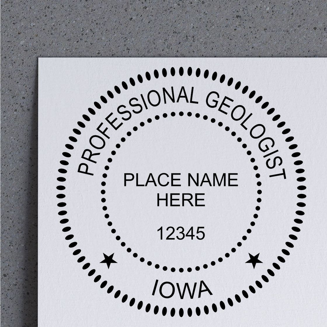 A lifestyle photo showing a stamped image of the Slim Pre-Inked Iowa Professional Geologist Seal Stamp on a piece of paper