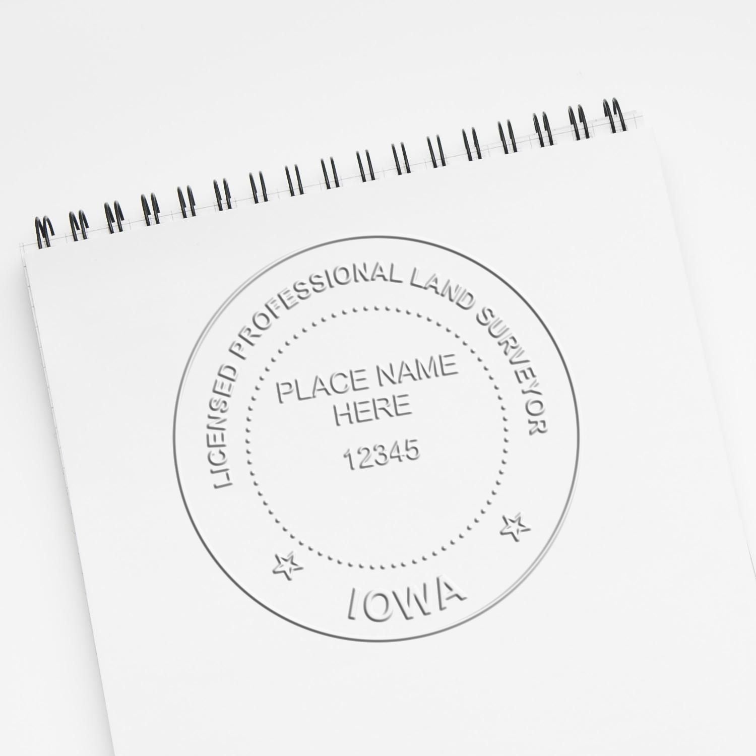 Another Example of a stamped impression of the State of Iowa Soft Land Surveyor Embossing Seal on a piece of office paper.