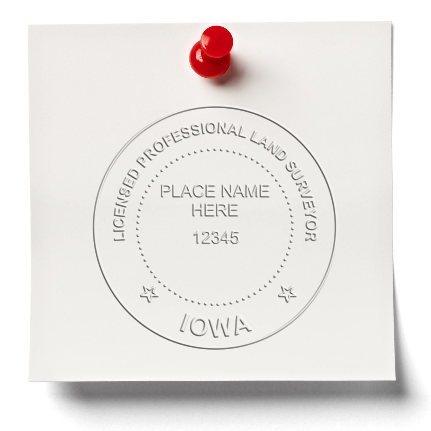 A lifestyle photo showing a stamped image of the Handheld Iowa Land Surveyor Seal on a piece of paper