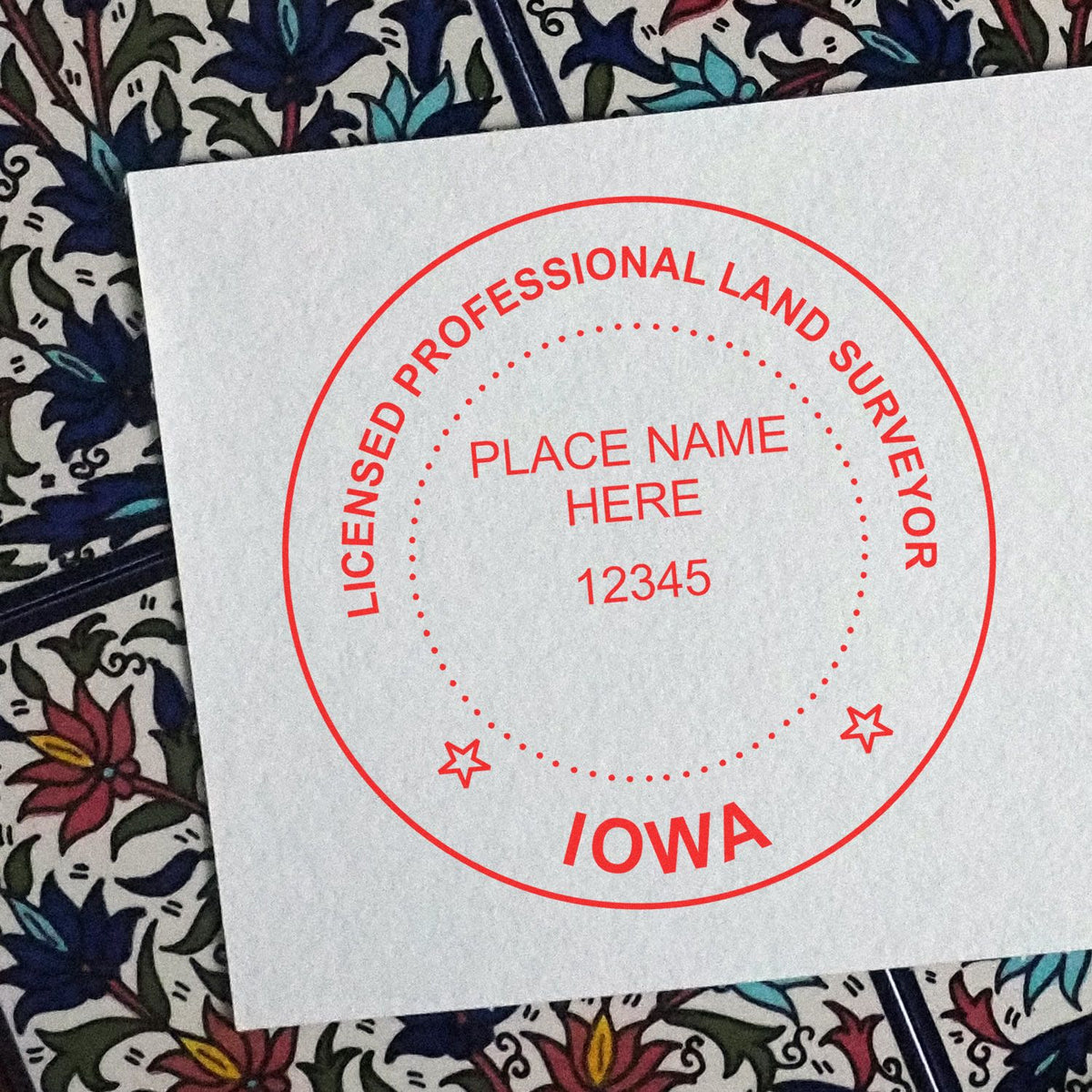 A lifestyle photo showing a stamped image of the Slim Pre-Inked Iowa Land Surveyor Seal Stamp on a piece of paper