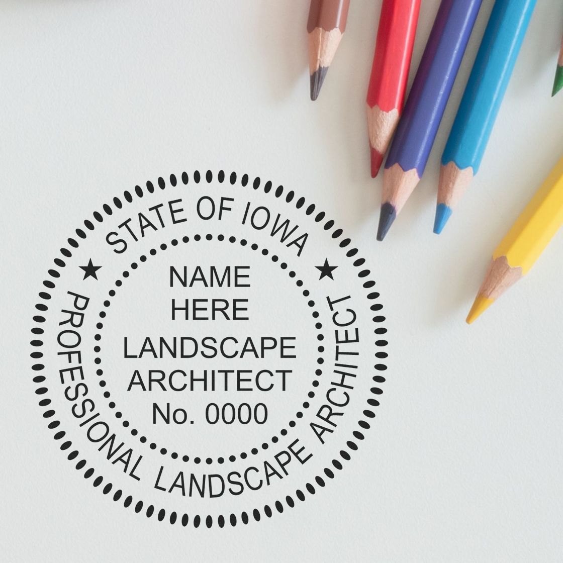 A lifestyle photo showing a stamped image of the Iowa Landscape Architectural Seal Stamp on a piece of paper