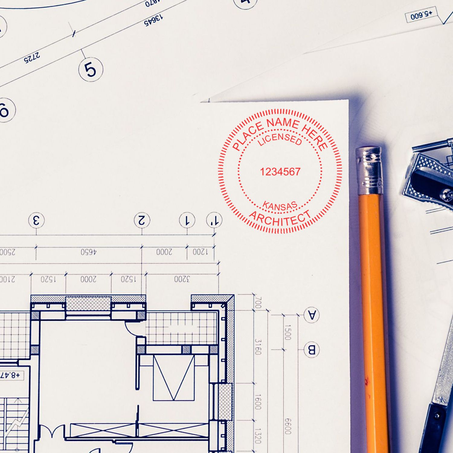 Self Inking Kansas Architect Stamp on a white paper with architectural blueprints, pencil, and drafting tools in the background.