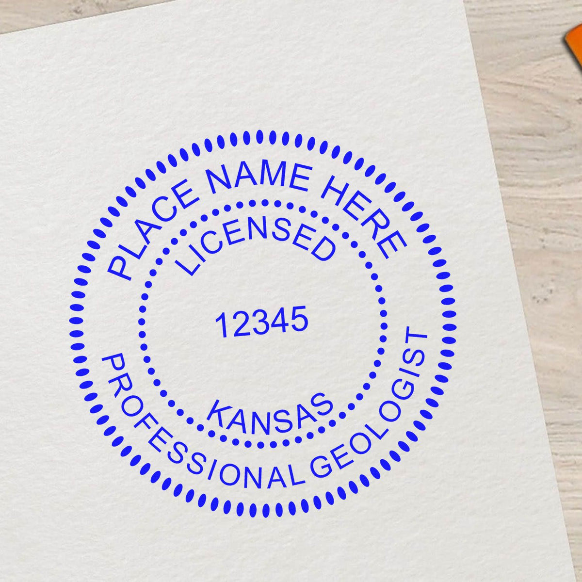 An alternative view of the Slim Pre-Inked Kansas Professional Geologist Seal Stamp stamped on a sheet of paper showing the image in use