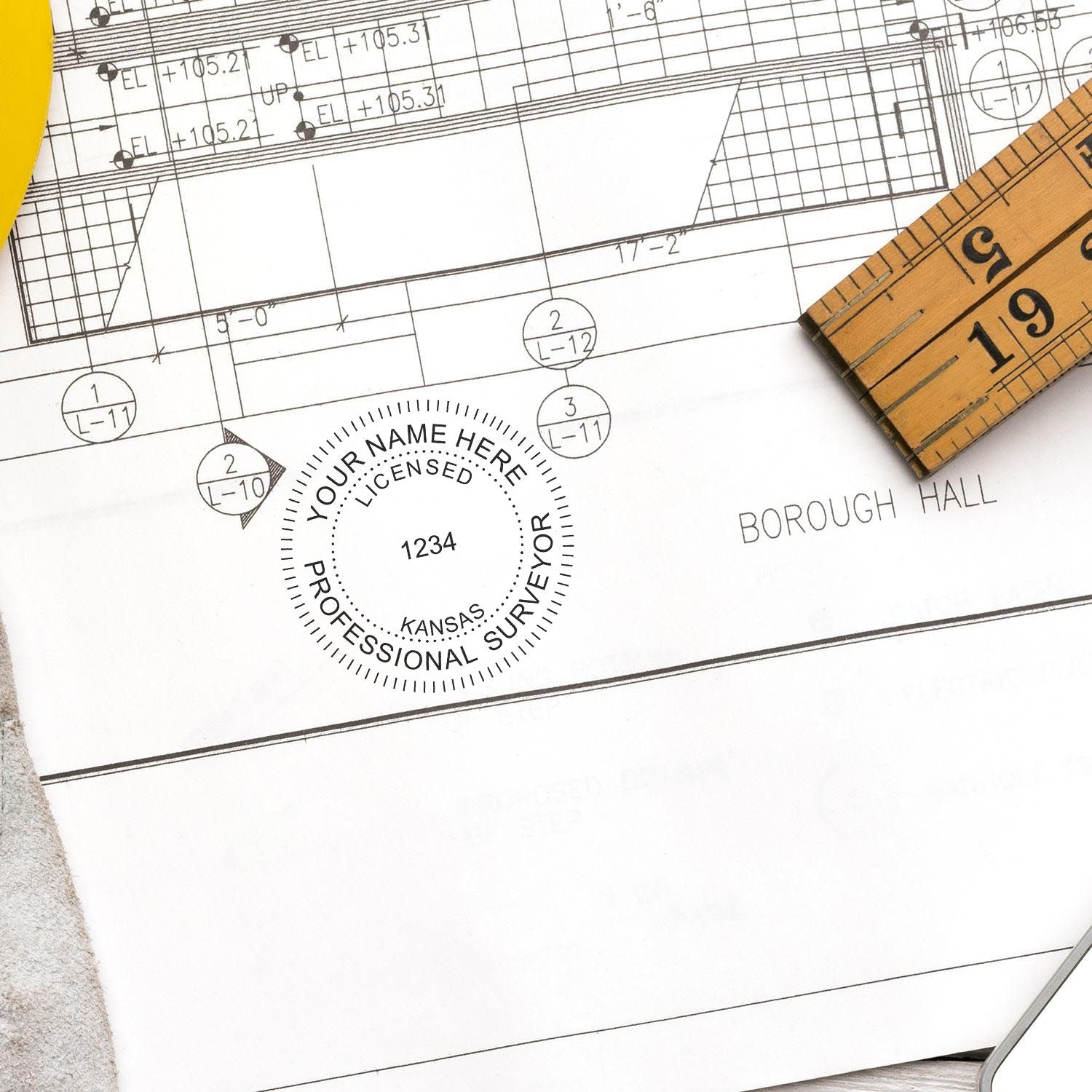 Digital Kansas Land Surveyor Stamp, Electronic Seal for Kansas Land Surveyor, stamped on a blueprint with a ruler nearby.