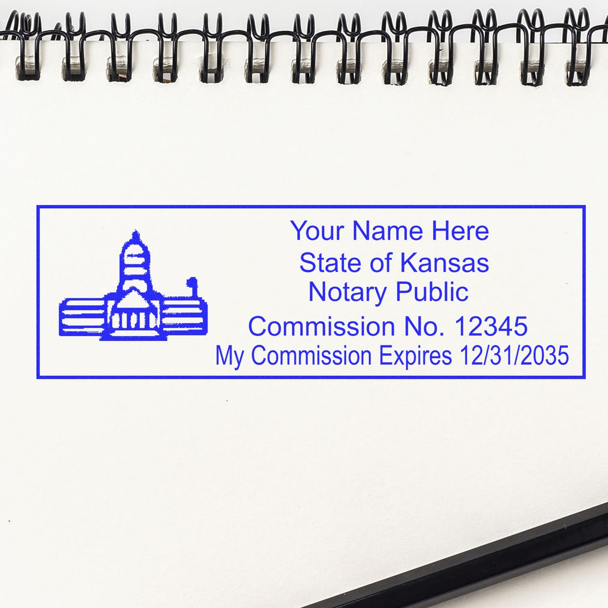 A lifestyle photo showing a stamped image of the Wooden Handle Kansas State Seal Notary Public Stamp on a piece of paper