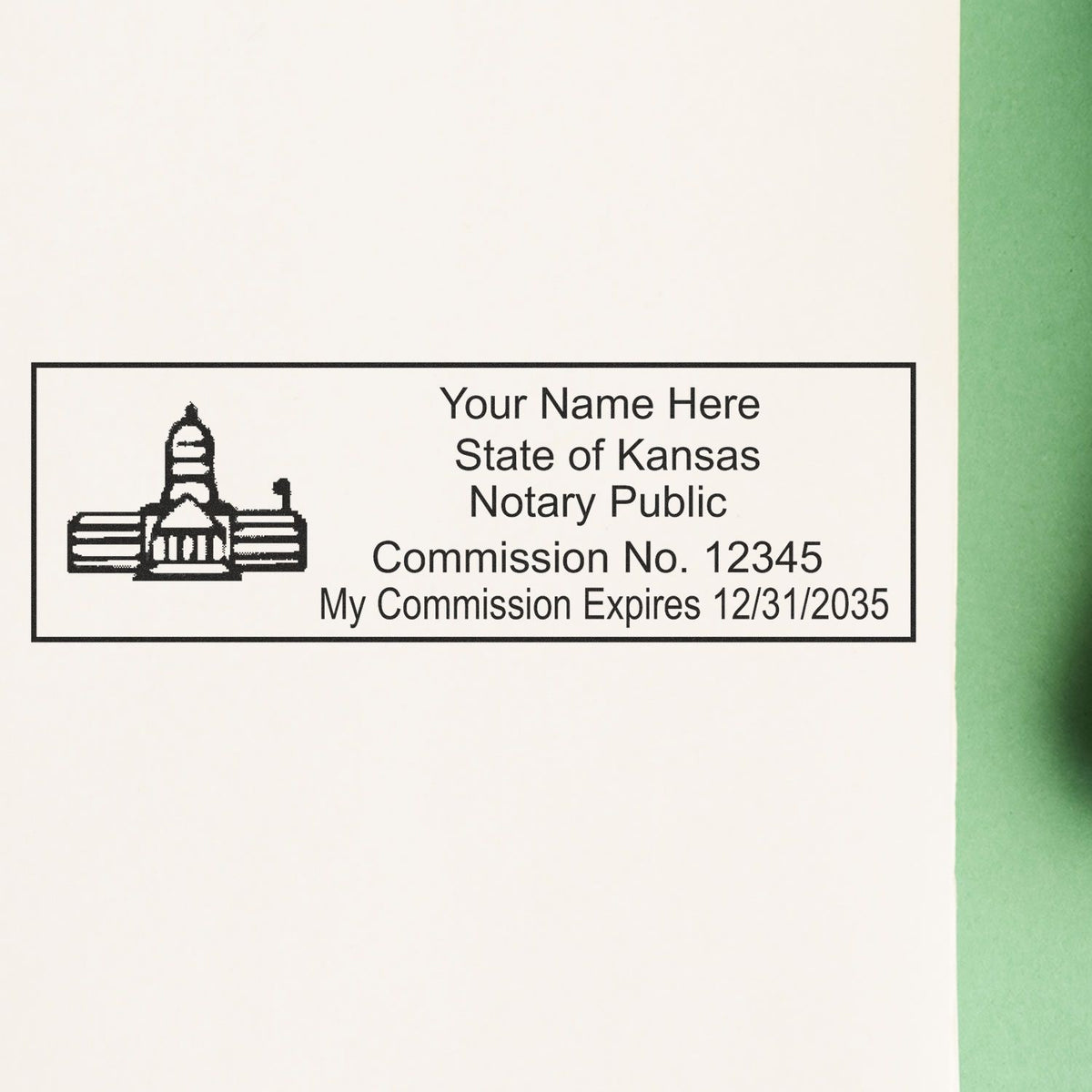A lifestyle photo showing a stamped image of the Heavy-Duty Kansas Rectangular Notary Stamp on a piece of paper