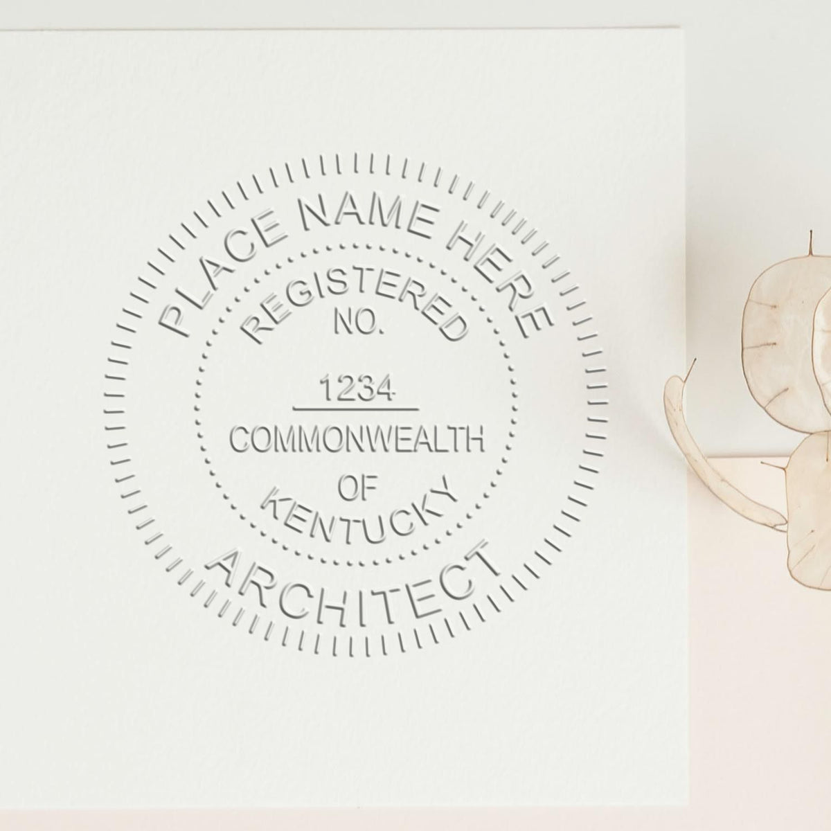An alternative view of the State of Kentucky Long Reach Architectural Embossing Seal stamped on a sheet of paper showing the image in use