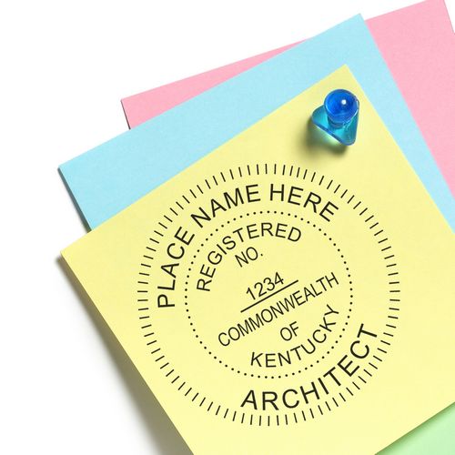 Premium MaxLight Pre-Inked Kentucky Architectural Stamp on colorful papers with a push pin, displaying a customizable architect seal.