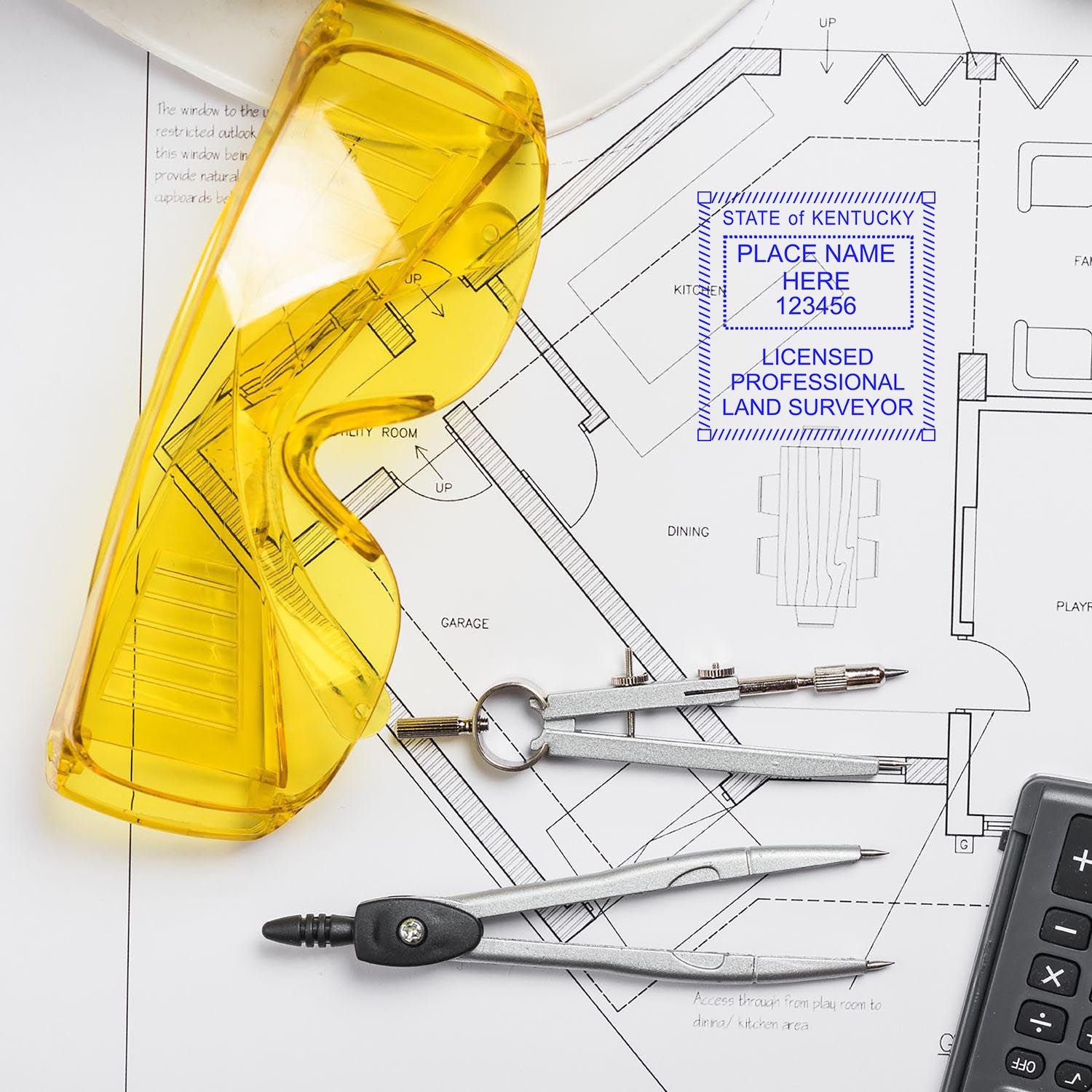 Yellow safety glasses, compass, and calculator on a blueprint with Self Inking Kentucky Land Surveyor Stamp imprint.