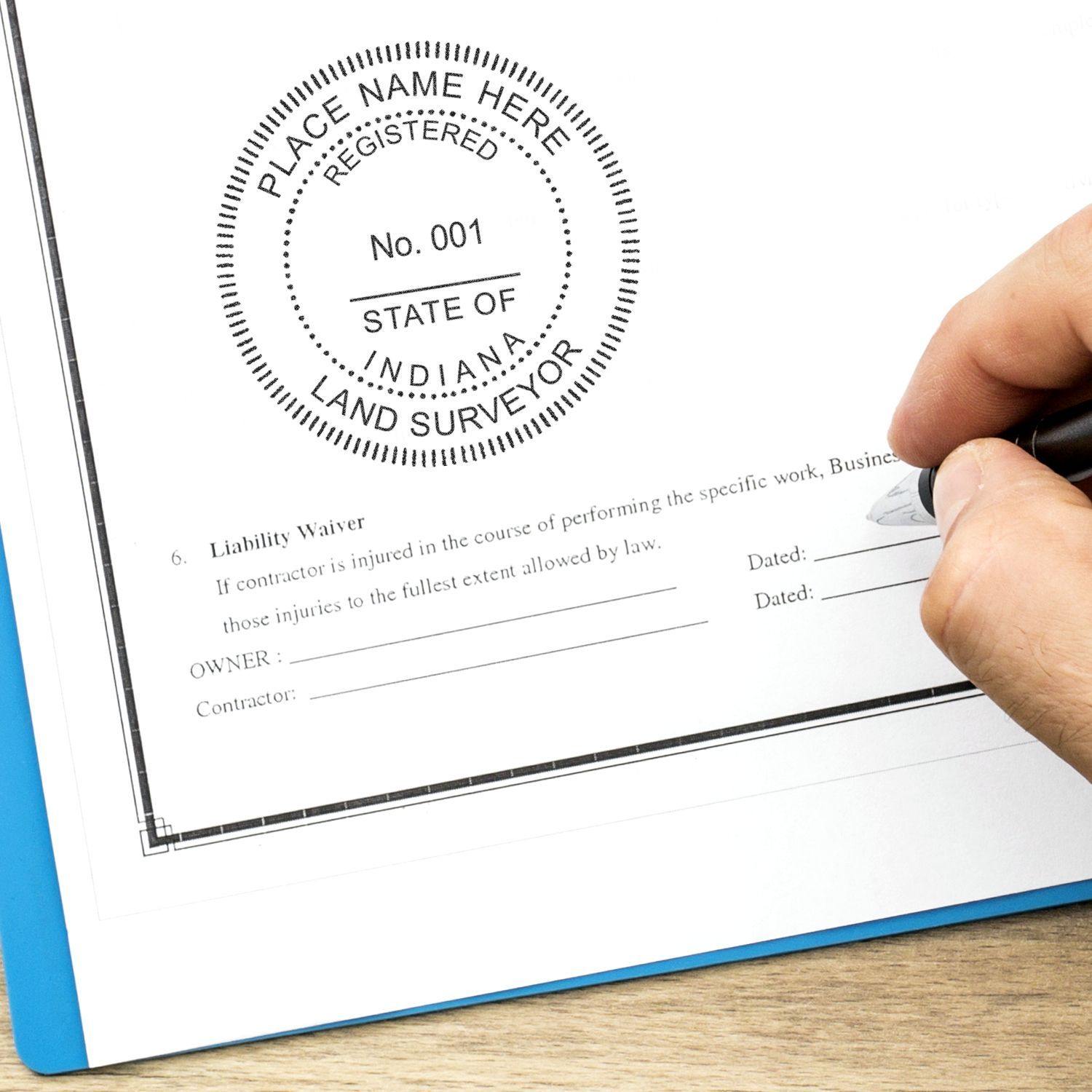 Hand holding pen near document stamped with Land Surveyor Regular Rubber Stamp of Seal showing a registered seal with customizable details.