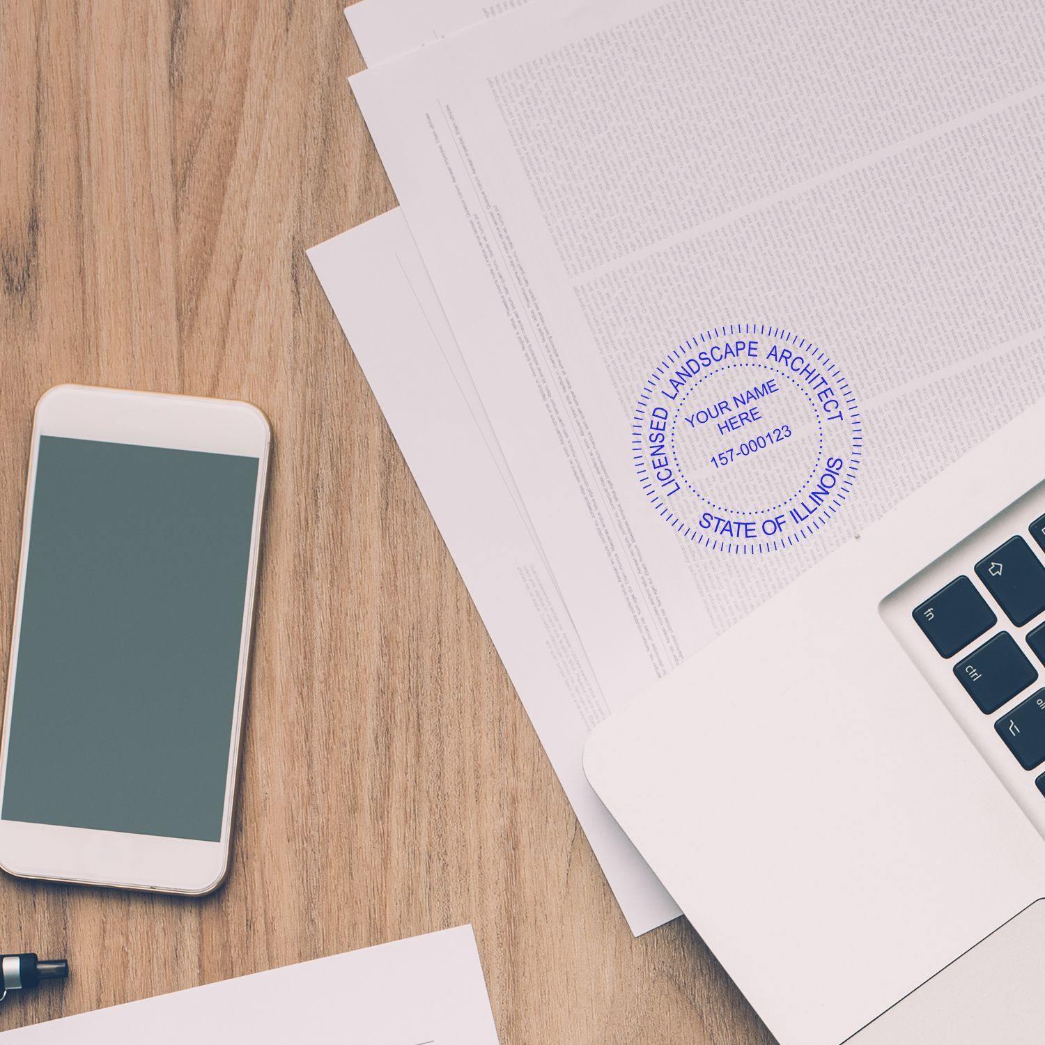 Landscape Architect Regular Rubber Stamp of Seal in blue ink on a document, placed on a wooden desk with a phone and laptop nearby.