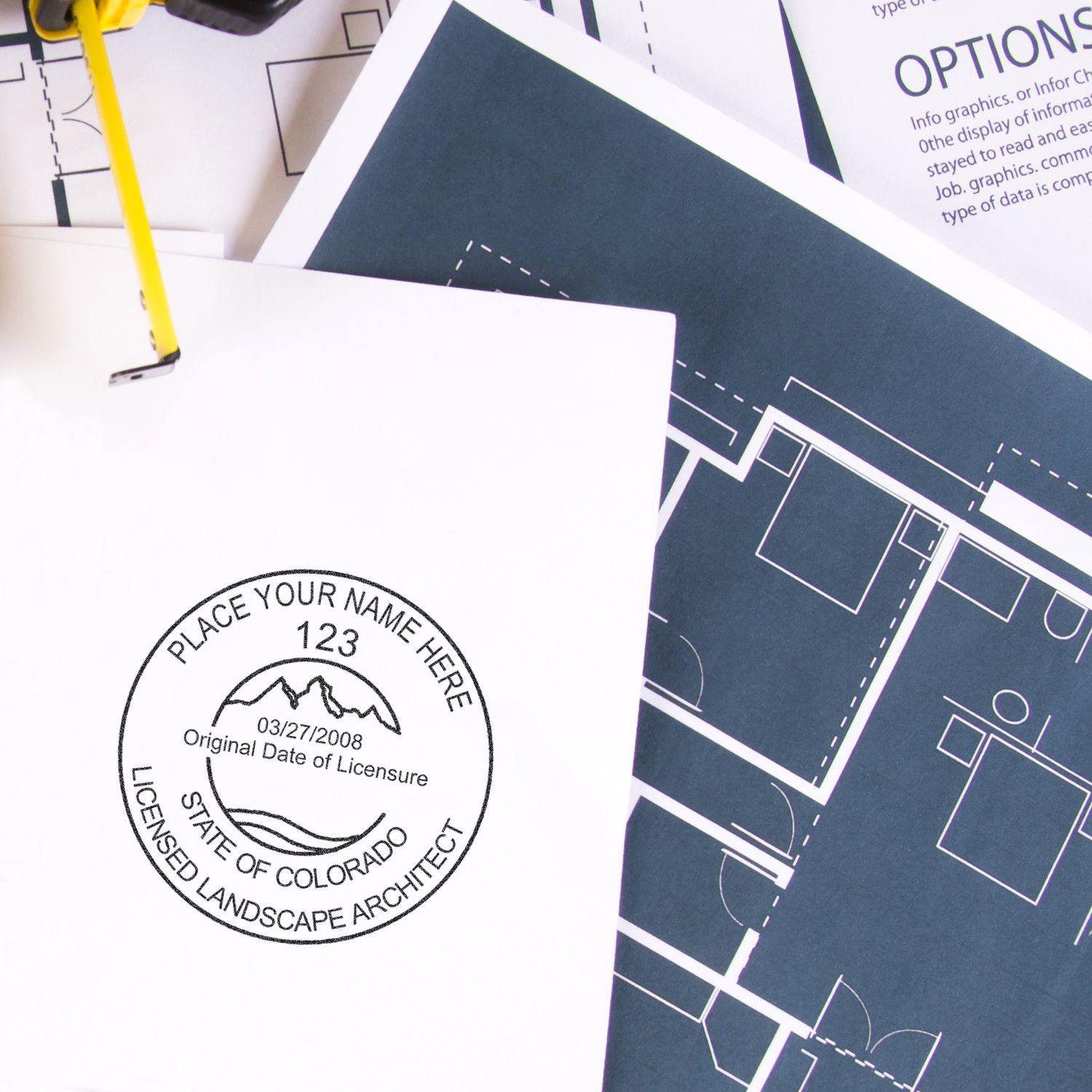 Landscape Architect Slim Pre-Inked Rubber Stamp of Seal used on a document with architectural blueprints in the background.