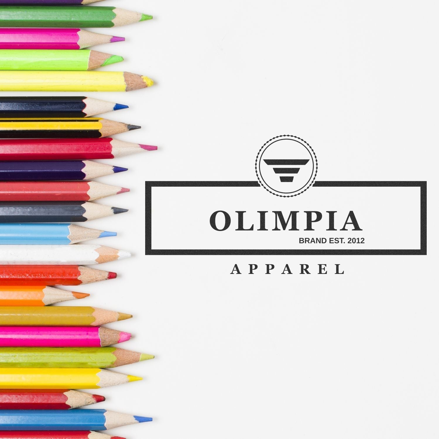 Custom Self Inking Stamp Trodat 4931 Size 1-1/8 x 2-3/4 stamping Olimpia Apparel logo on white paper with colored pencils beside it.