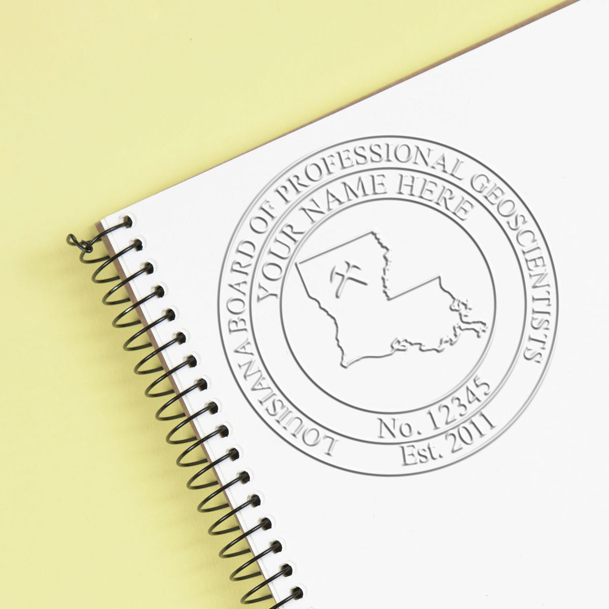 An in use photo of the Louisiana Geologist Desk Seal showing a sample imprint on a cardstock