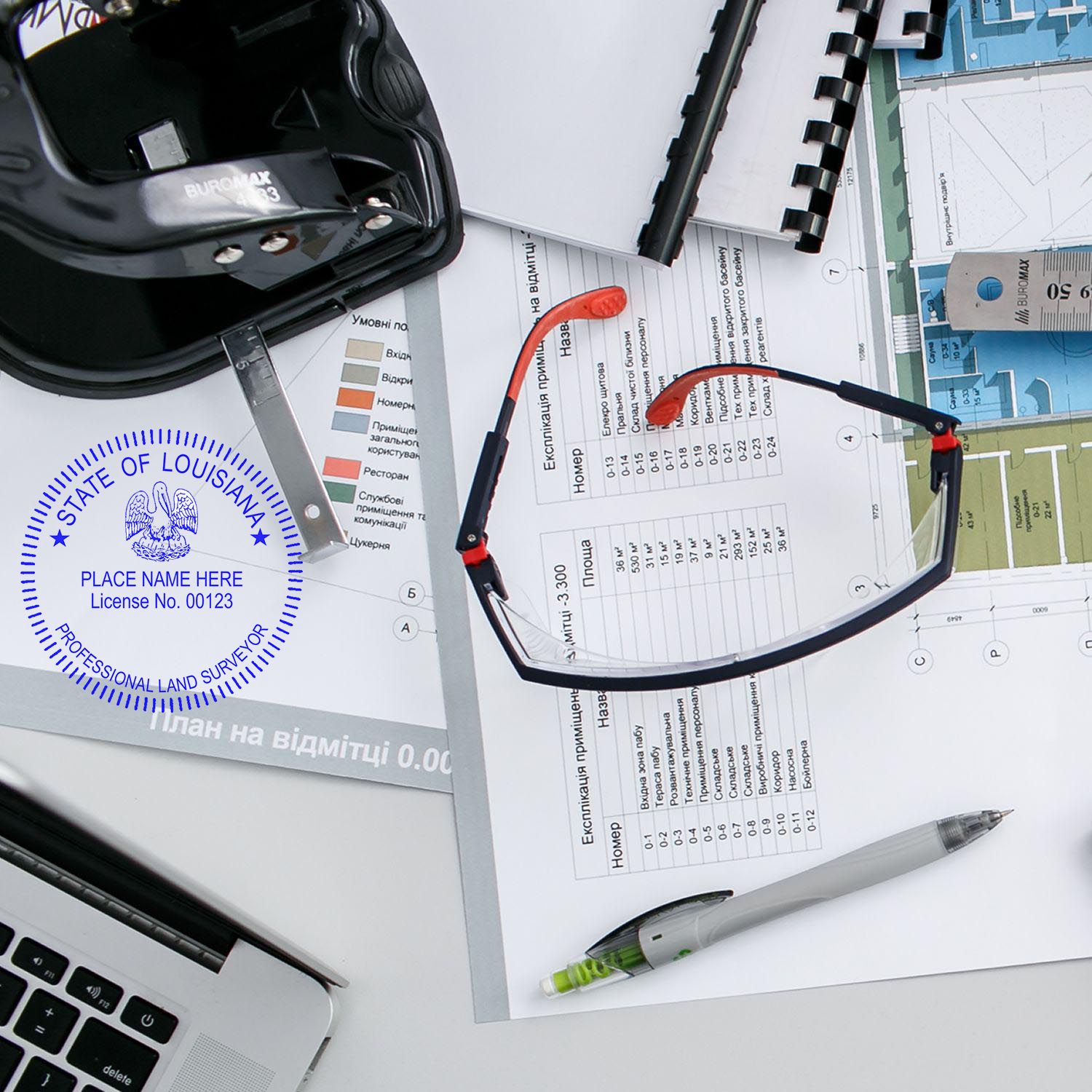 Self Inking Louisiana Land Surveyor Stamp in use on a desk with glasses, documents, and a pen.