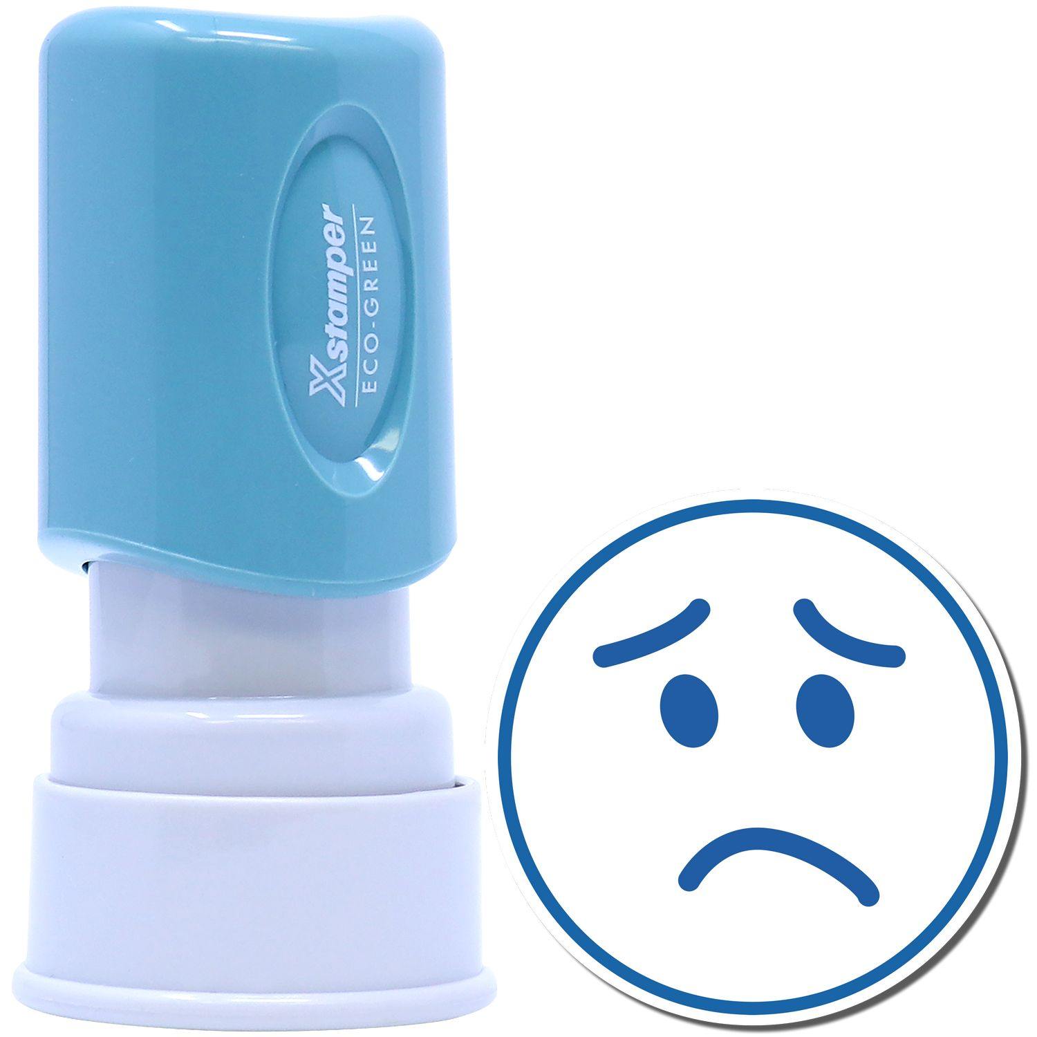 An xstamper stamp with a stamped image showing how a frown face in a round shape is displayed after stamping.