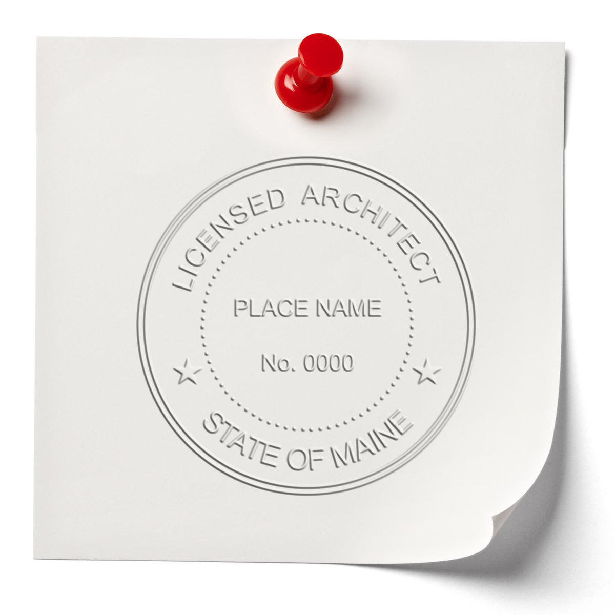 A lifestyle photo showing a stamped image of the Handheld Maine Architect Seal Embosser on a piece of paper