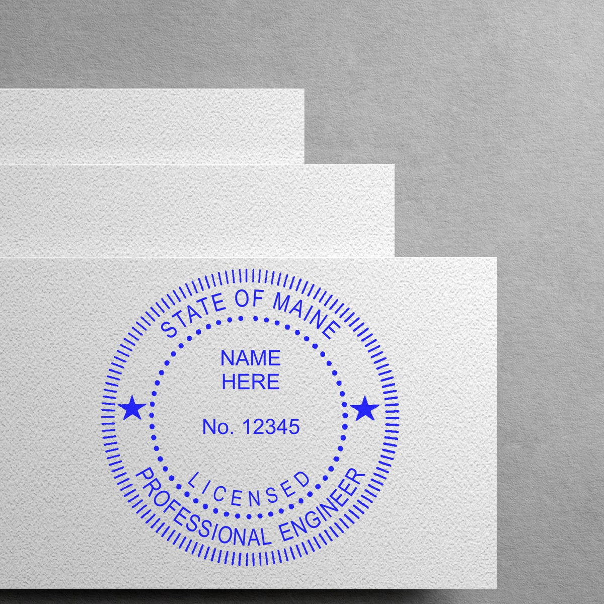 A lifestyle photo showing a stamped image of the Premium MaxLight Pre-Inked Maine Engineering Stamp on a piece of paper