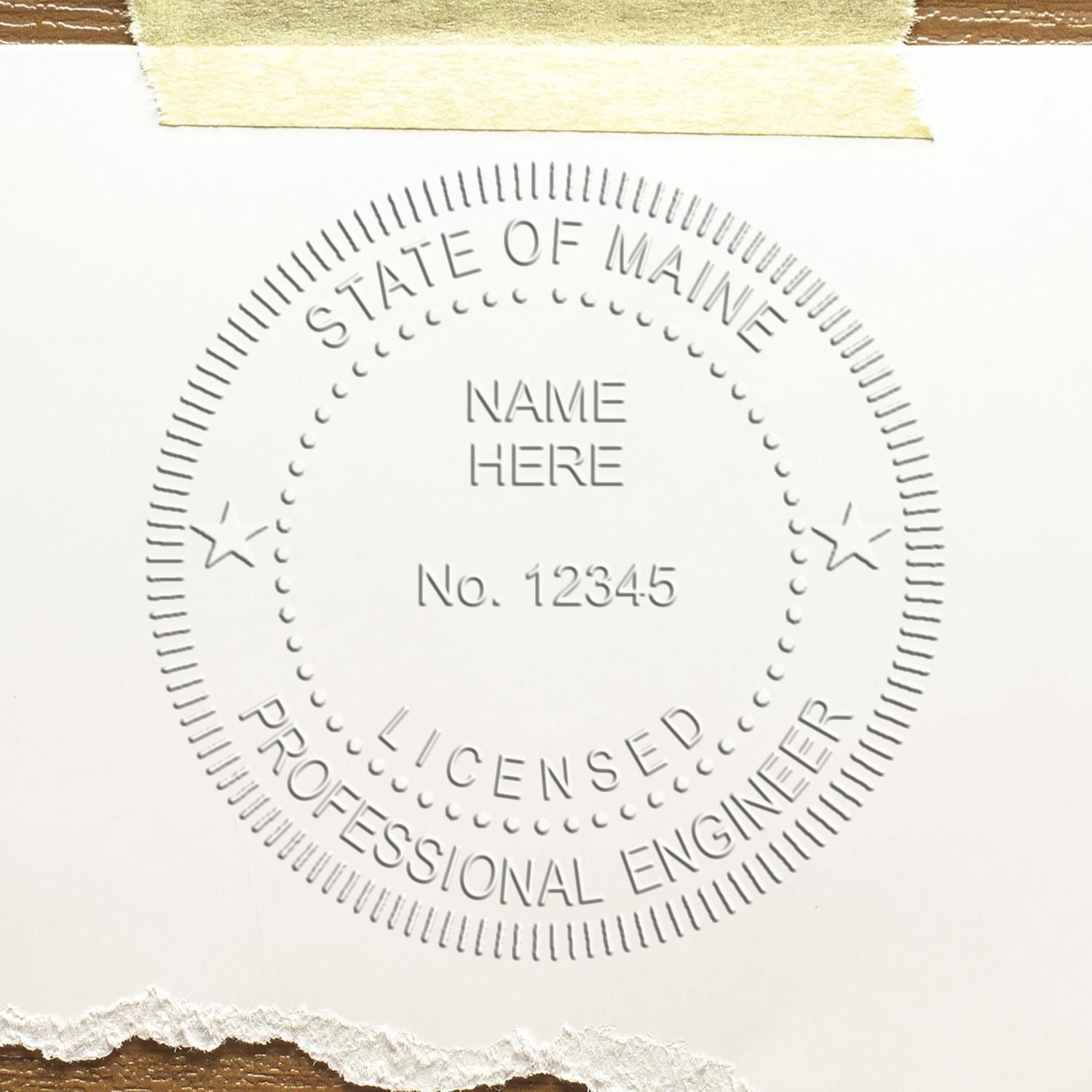 The main image for the Handheld Maine Professional Engineer Embosser depicting a sample of the imprint and electronic files