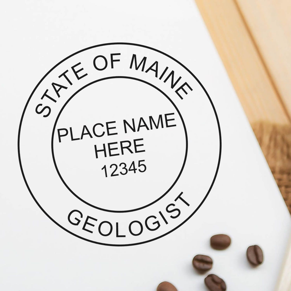 A lifestyle photo showing a stamped image of the Premium MaxLight Pre-Inked Maine Geology Stamp on a piece of paper