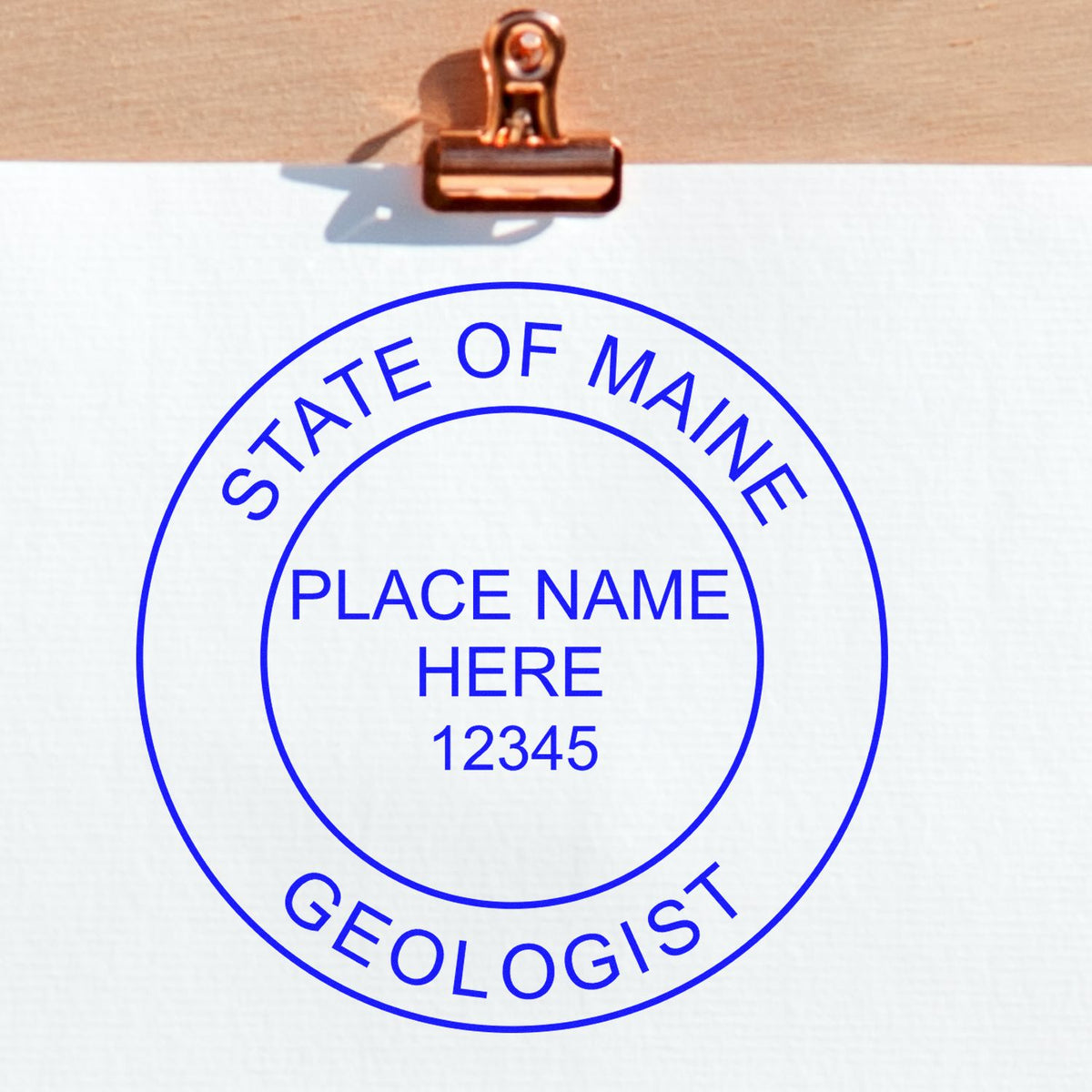 An alternative view of the Slim Pre-Inked Maine Professional Geologist Seal Stamp stamped on a sheet of paper showing the image in use