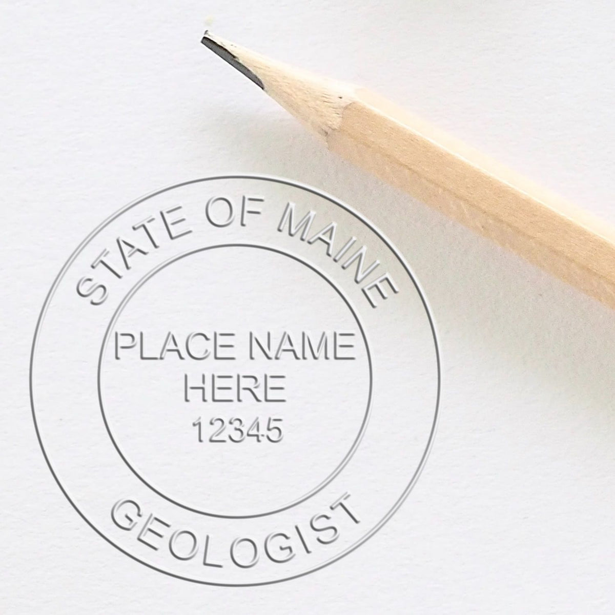 An alternative view of the Handheld Maine Professional Geologist Embosser stamped on a sheet of paper showing the image in use