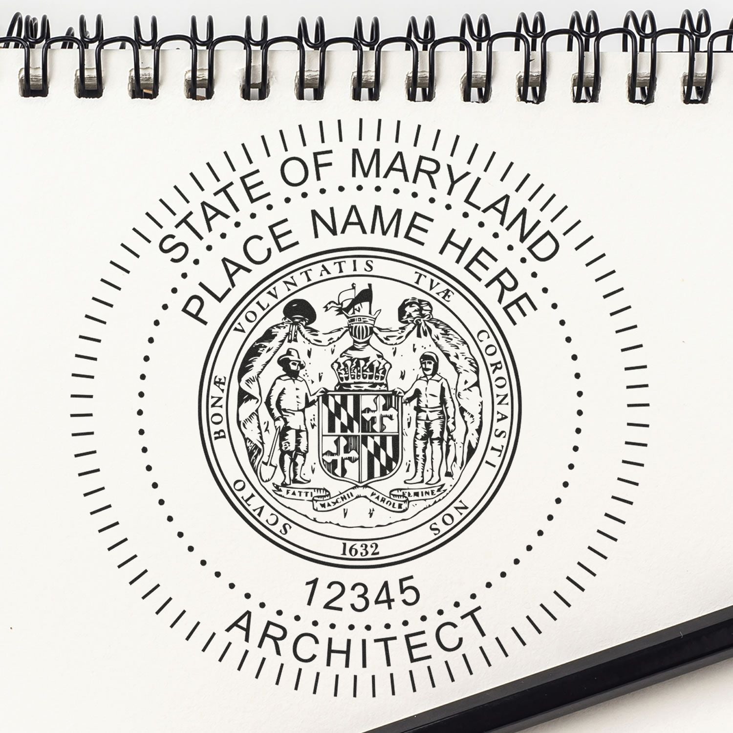 Premium MaxLight Pre-Inked Maryland Architectural Stamp on a spiral-bound notebook with a pen nearby, featuring customizable text and seal design.