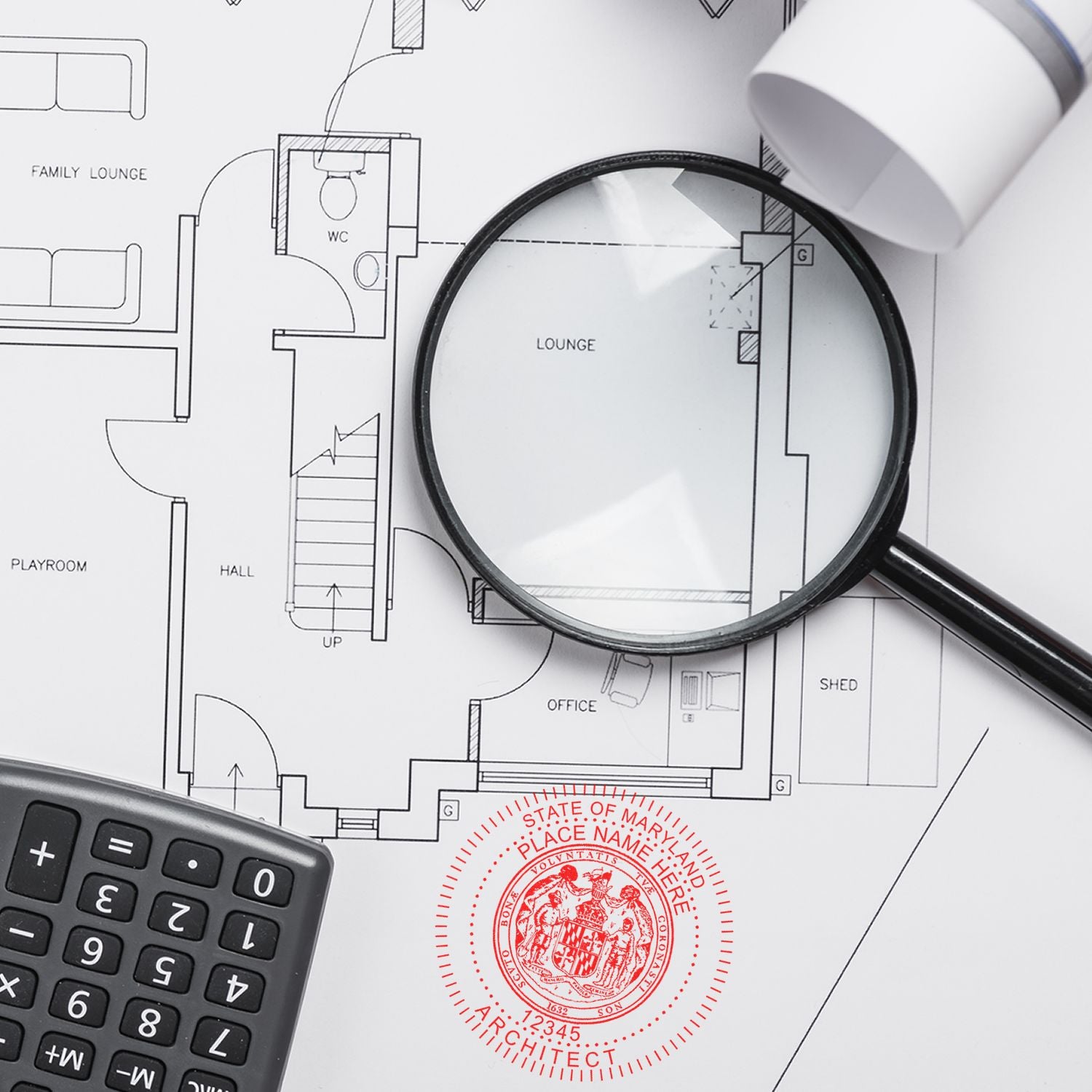 Magnifying glass and calculator on architectural blueprint with Premium MaxLight Pre-Inked Maryland Architectural Stamp in red at the bottom.