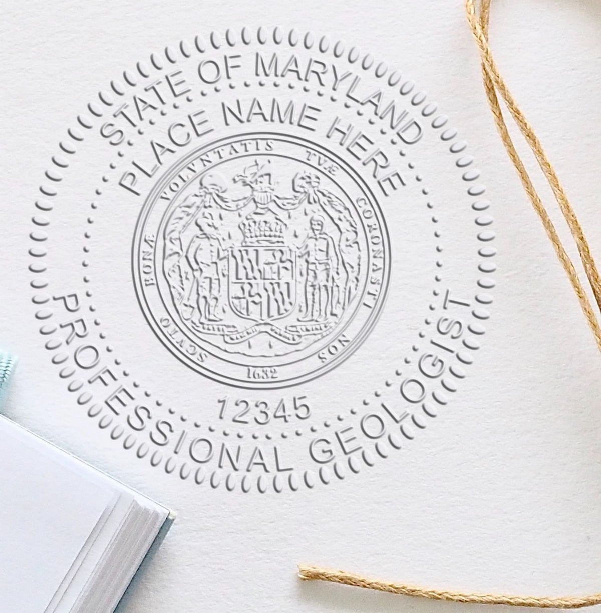 A stamped imprint of the State of Maryland Extended Long Reach Geologist Seal in this stylish lifestyle photo, setting the tone for a unique and personalized product.