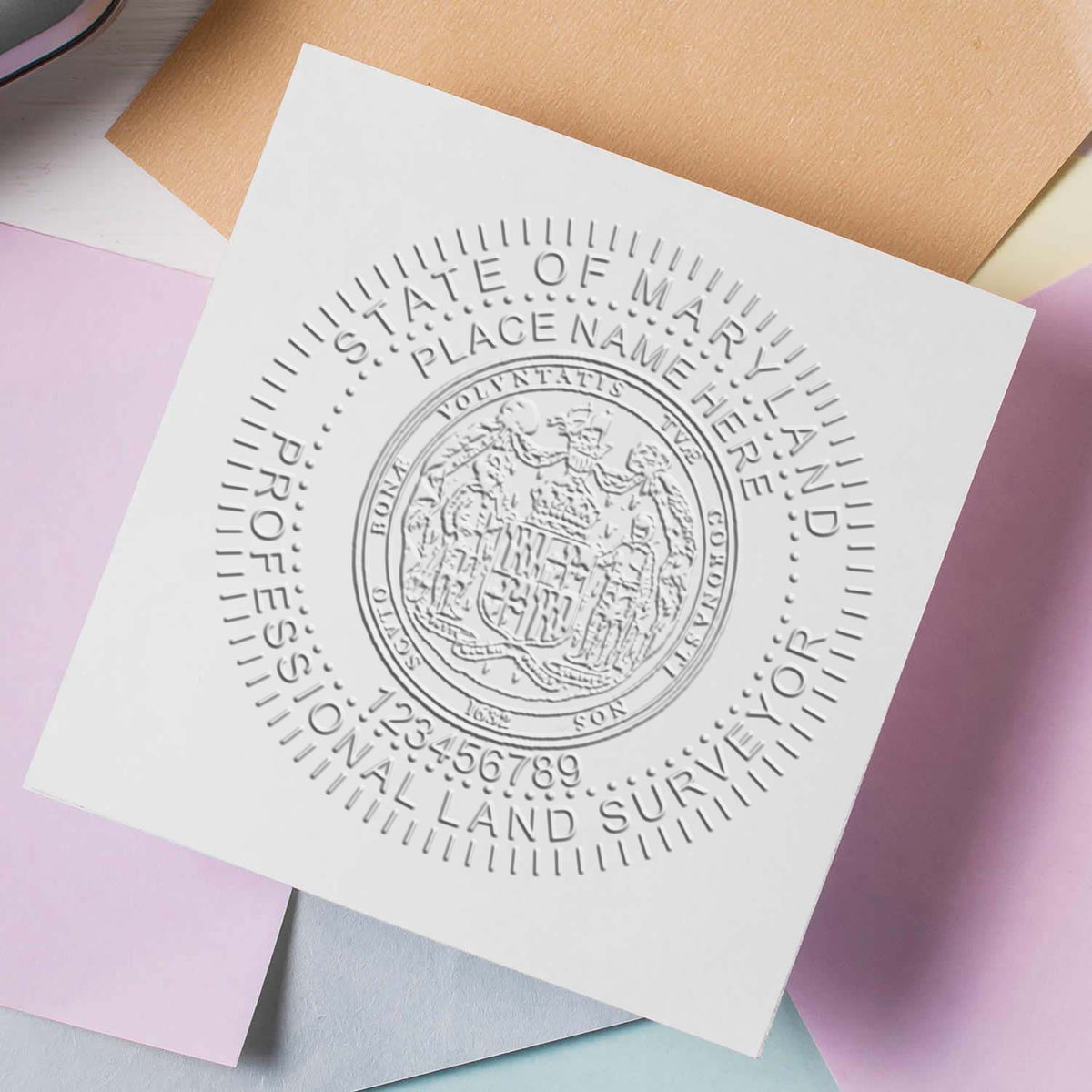 An in use photo of the Gift Maryland Land Surveyor Seal showing a sample imprint on a cardstock