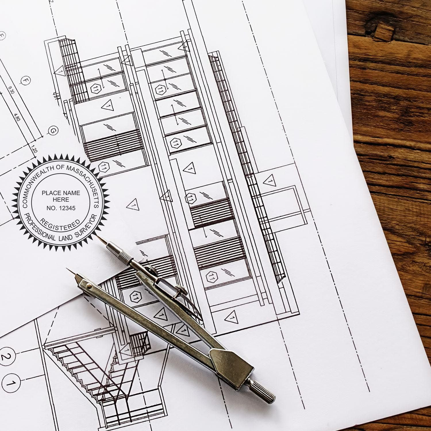 Digital Massachusetts Land Surveyor Stamp, Electronic Seal for MA Land Surveyor, placed on architectural blueprints with a compass.