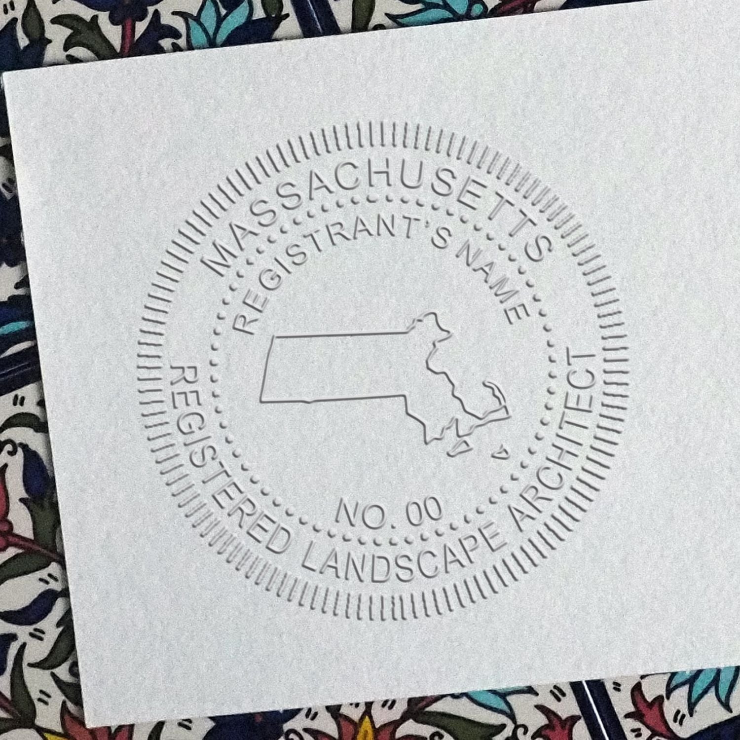 A stamped impression of the Massachusetts Desk Landscape Architectural Seal Embosser in this stylish lifestyle photo, setting the tone for a unique and personalized product.