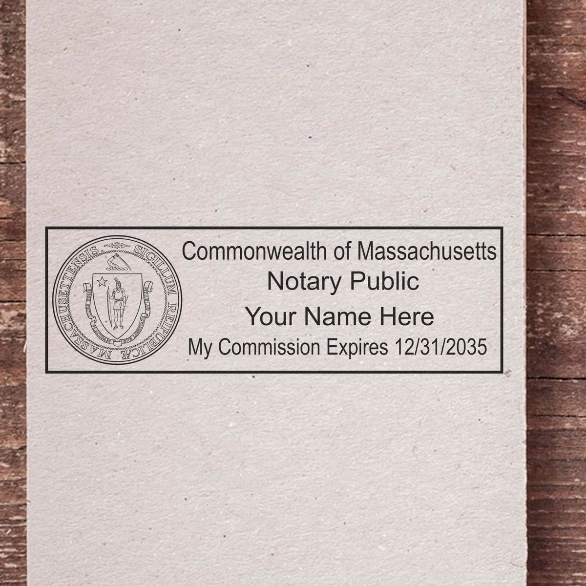 A lifestyle photo showing a stamped image of the Wooden Handle Massachusetts State Seal Notary Public Stamp on a piece of paper