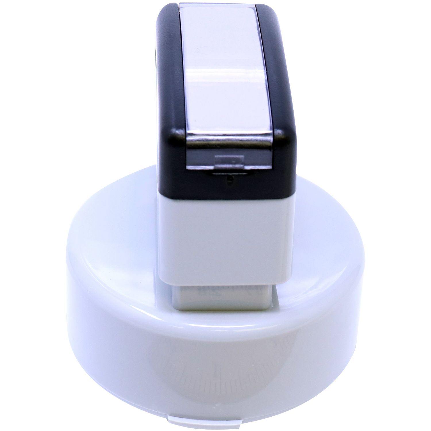 Forester MaxLight Pre Inked Rubber Stamp of Seal with a round white base and a black and silver handle, shown from a top-side angle.