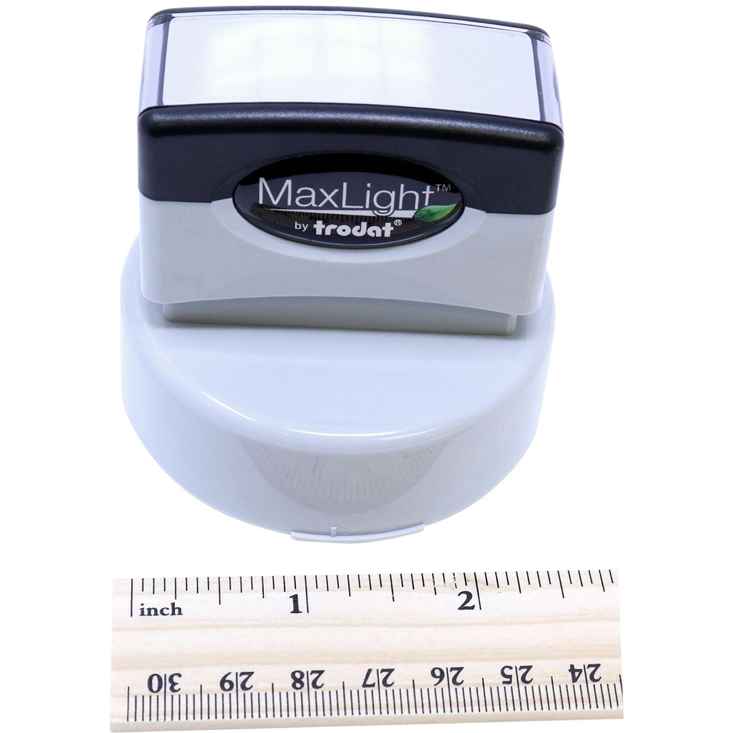 Geologist MaxLight Pre Inked Rubber Stamp of Seal by Trodat, shown with a ruler for scale, highlighting its compact size and design.