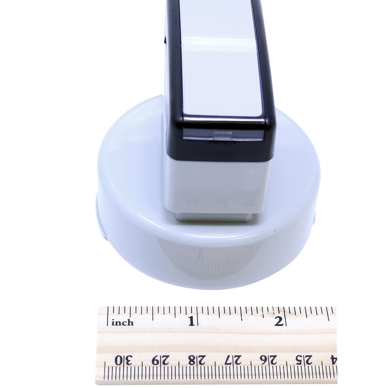 MaxLight Pre-Inked Professional Engineer Stamp of Seal, shown from the side, with a black and white design, placed next to a ruler for scale.